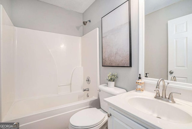 full bathroom featuring toilet, vanity, bathtub / shower combination, and a textured ceiling