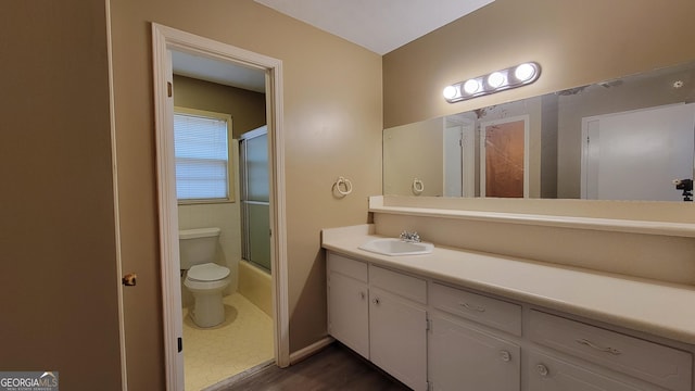 full bathroom with shower / bath combination with glass door, vanity, and toilet