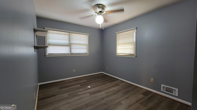 unfurnished room featuring ceiling fan and dark hardwood / wood-style floors