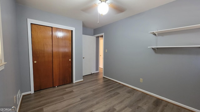 unfurnished bedroom featuring ceiling fan, hardwood / wood-style floors, and a closet