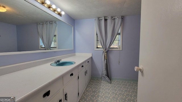 bathroom featuring vanity and a textured ceiling