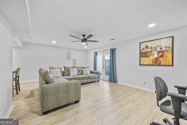 living room with ceiling fan and light wood-type flooring