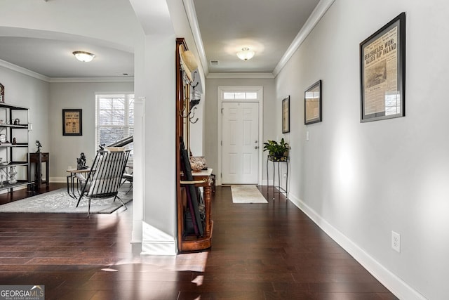 foyer entrance with dark wood-type flooring and ornamental molding