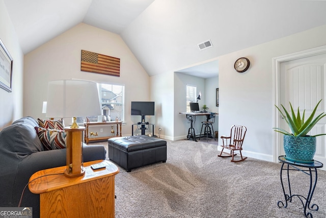 carpeted living room with vaulted ceiling and a healthy amount of sunlight