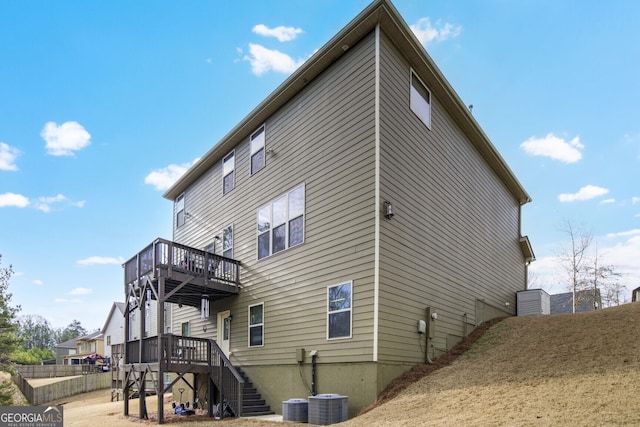 view of side of property with central AC and a wooden deck