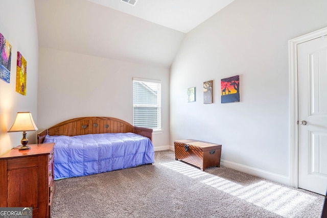 bedroom featuring lofted ceiling and carpet flooring