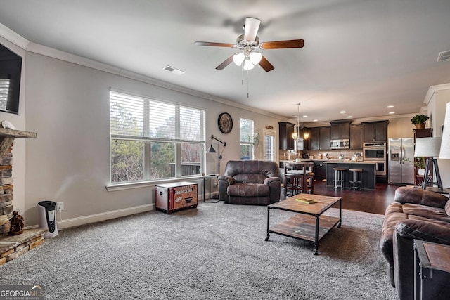 living room featuring ceiling fan and ornamental molding