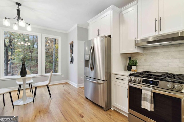 kitchen featuring ornamental molding, appliances with stainless steel finishes, light wood-type flooring, and white cabinets