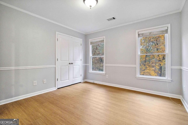 unfurnished room with light hardwood / wood-style flooring and ornamental molding