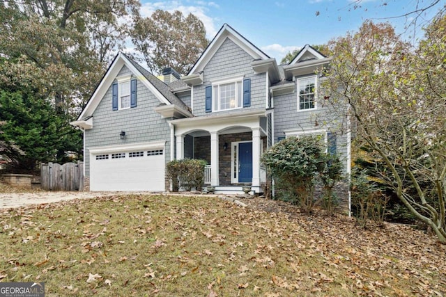 view of front of property featuring a garage and a front lawn