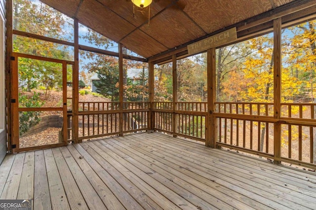 unfurnished sunroom with lofted ceiling