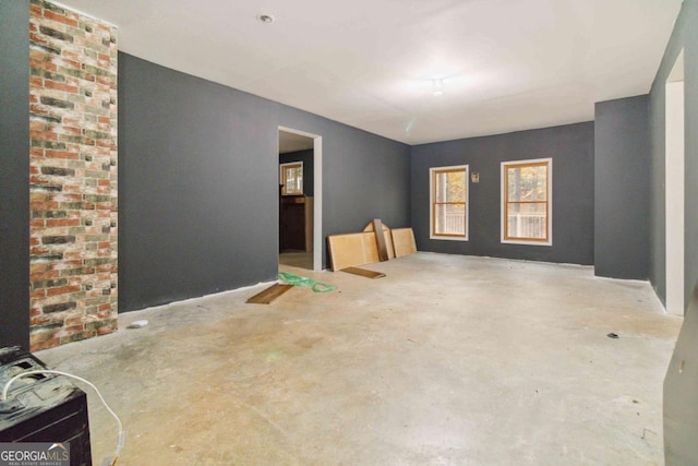 unfurnished room with concrete flooring