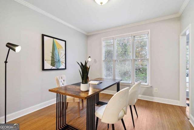 dining area featuring hardwood / wood-style flooring and crown molding