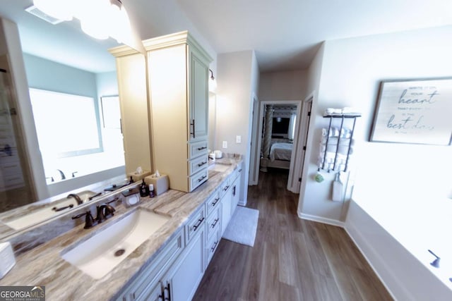 bathroom featuring vanity, a bathtub, and hardwood / wood-style flooring