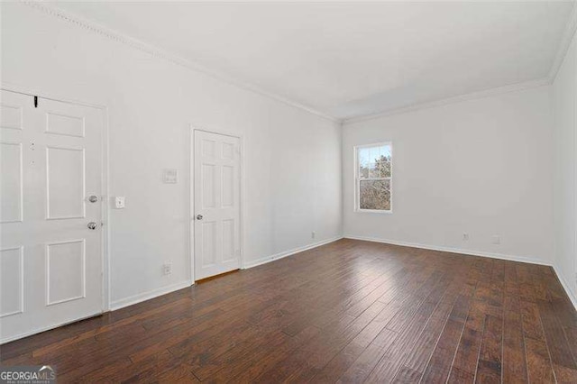 spare room with crown molding and dark hardwood / wood-style floors