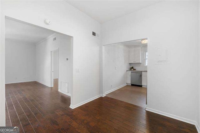 unfurnished room with dark wood-type flooring