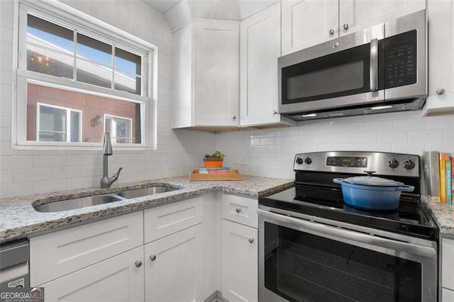 kitchen with white cabinetry, appliances with stainless steel finishes, and sink