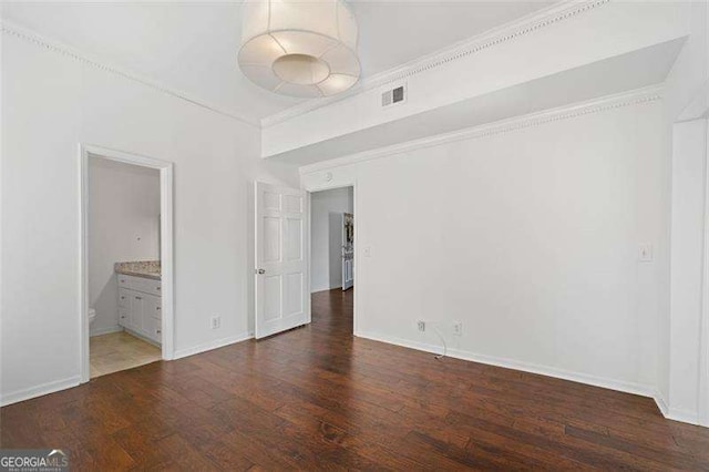 empty room featuring crown molding and dark hardwood / wood-style floors