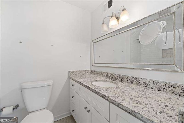 bathroom featuring vanity and toilet