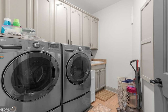 laundry room featuring cabinets and separate washer and dryer