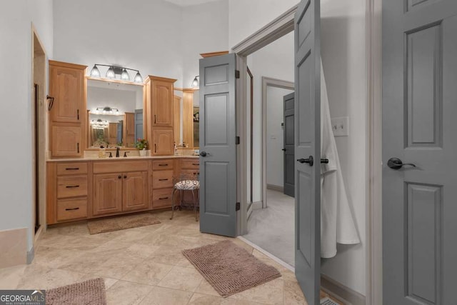 bathroom featuring vanity and a high ceiling