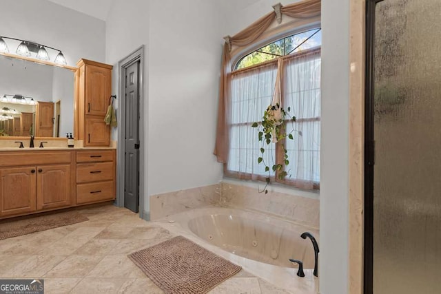 bathroom with vanity and independent shower and bath