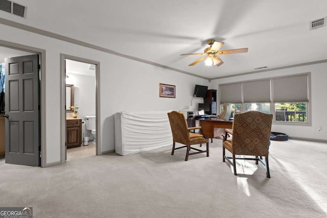 carpeted office space featuring crown molding and ceiling fan