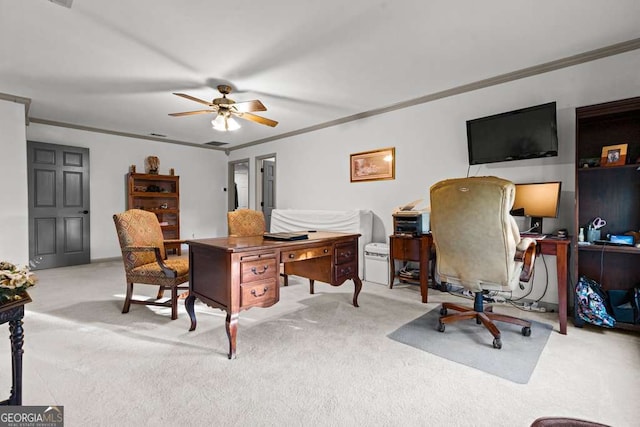 carpeted home office with ceiling fan and ornamental molding