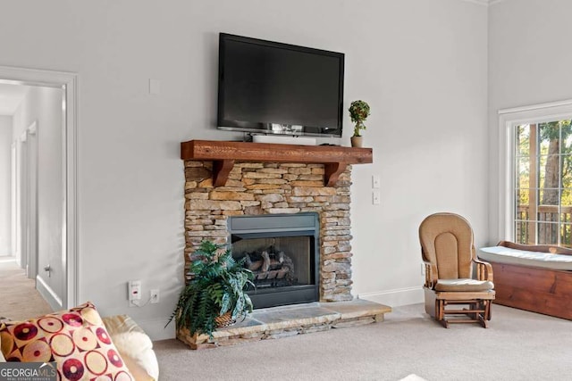 living room featuring a fireplace and carpet