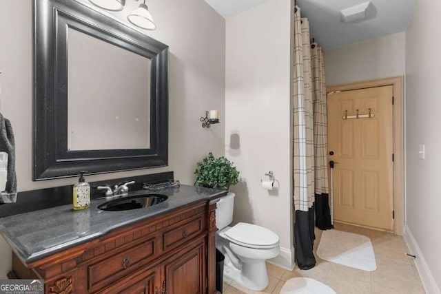 bathroom featuring tile patterned floors, vanity, and toilet