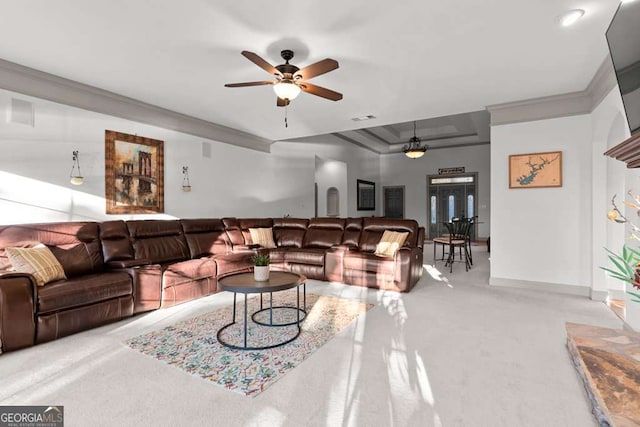 living room featuring ceiling fan, ornamental molding, and light carpet