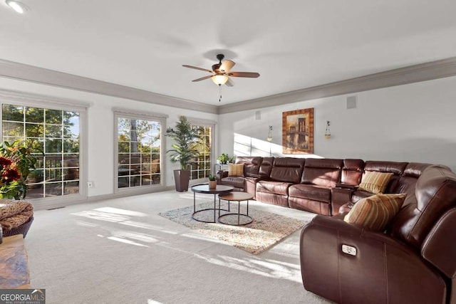 carpeted living room featuring ornamental molding and ceiling fan