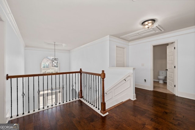 hall with ornamental molding, a chandelier, and dark hardwood / wood-style flooring