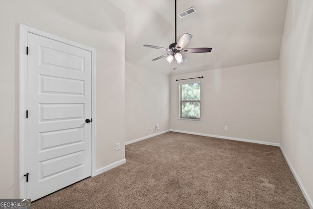 carpeted spare room with lofted ceiling and ceiling fan