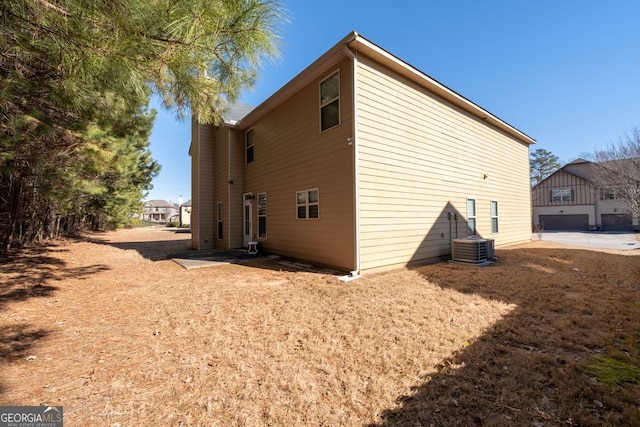 rear view of house featuring cooling unit