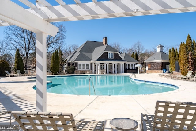 view of swimming pool with a patio and a pergola