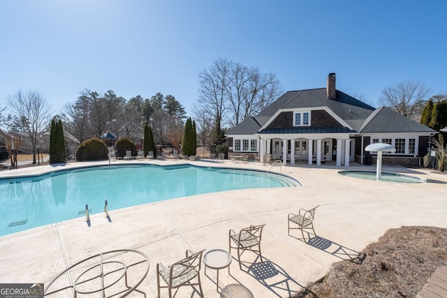 view of pool with a jacuzzi and a patio area