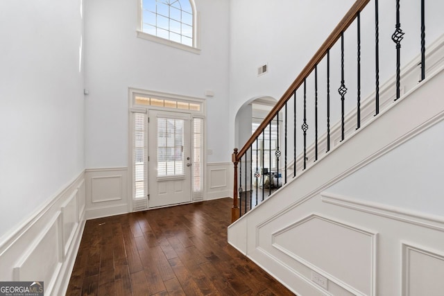 foyer featuring dark wood-type flooring and a healthy amount of sunlight