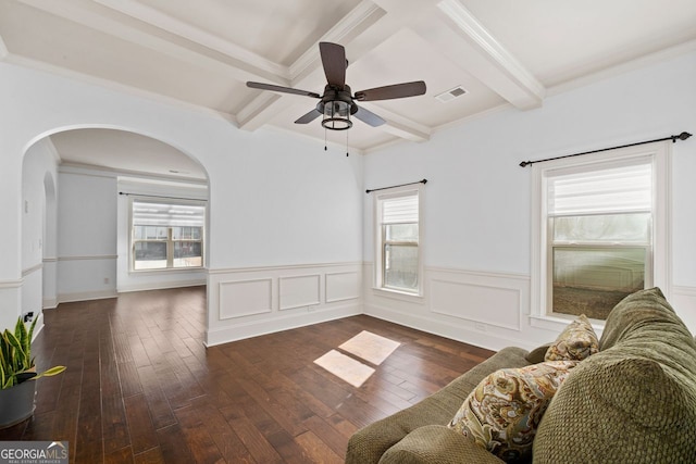 living room featuring plenty of natural light, beam ceiling, and dark hardwood / wood-style flooring