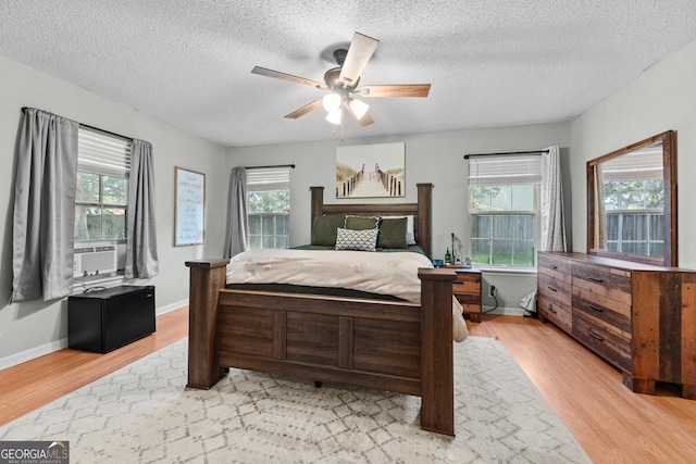 bedroom featuring multiple windows and light hardwood / wood-style flooring