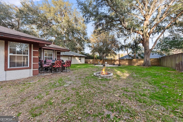 view of yard with a fire pit