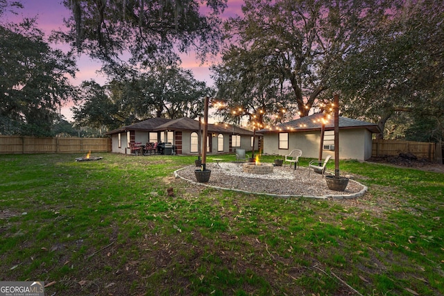 yard at dusk with a fire pit