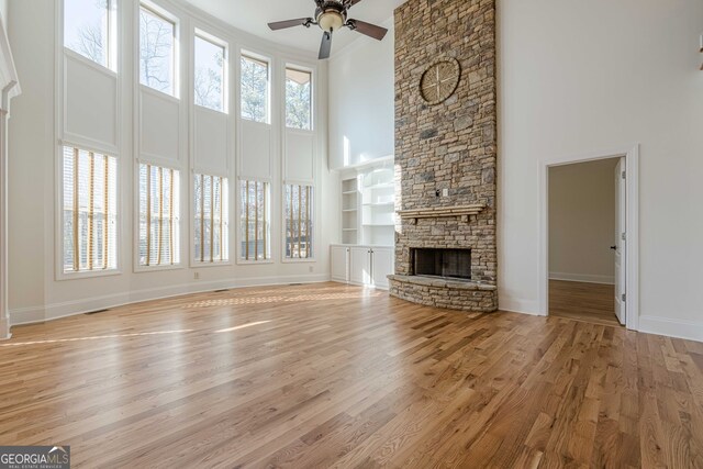 spare room featuring crown molding, ceiling fan, a raised ceiling, and light hardwood / wood-style floors