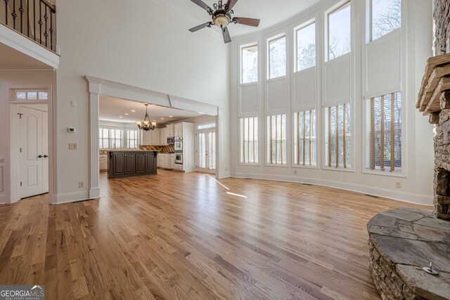 bathroom featuring a raised ceiling, crown molding, an enclosed shower, and vanity