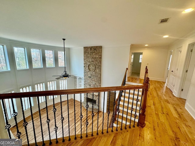 hall featuring crown molding and light hardwood / wood-style flooring