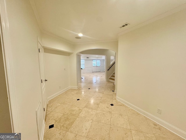 hall with crown molding and light tile patterned flooring