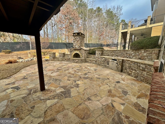 view of patio / terrace with a fireplace and an outdoor kitchen