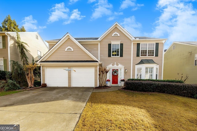 view of front property with a garage and a front yard