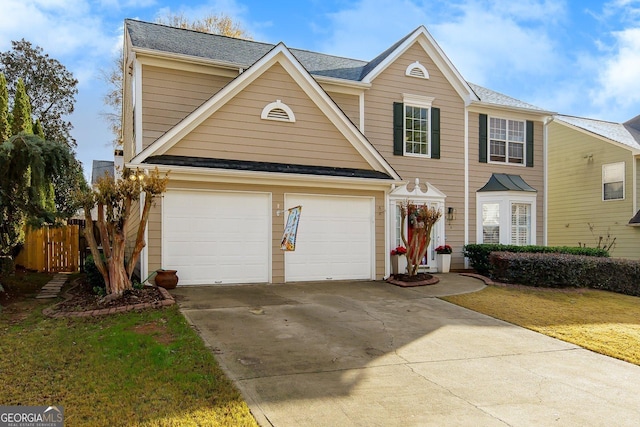 view of front of house with a garage and a front lawn