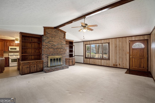 unfurnished living room with vaulted ceiling with beams, a textured ceiling, and a brick fireplace